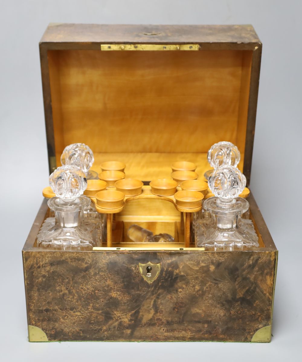 A Victorian pressed glass decanter part set, four decanters and four tots, within fitted brass mounted burr walnut case, 31cm wide